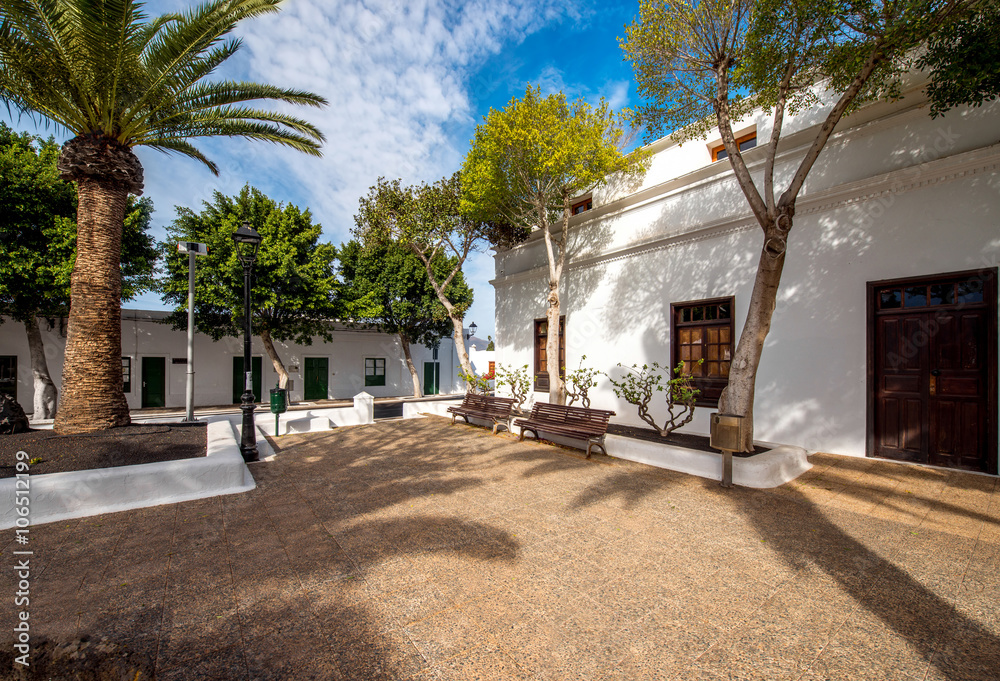 Street view with traditional whitewashed buildings in Yaiza village on Lanzarote island in Spain