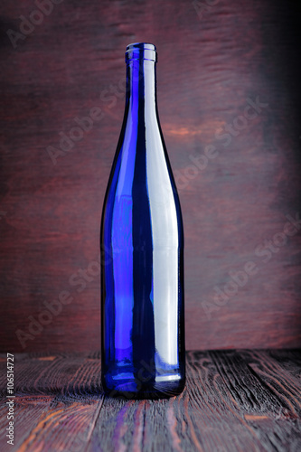 Blue bottle on a wooden background