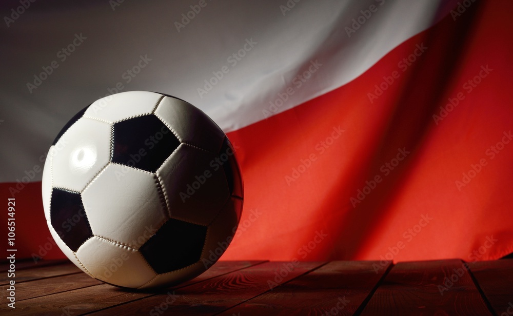Flag of Poland with football on wooden boards as the background.
