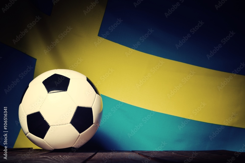 Flag of Sweden with football on wooden boards as the background. Vintage Style.