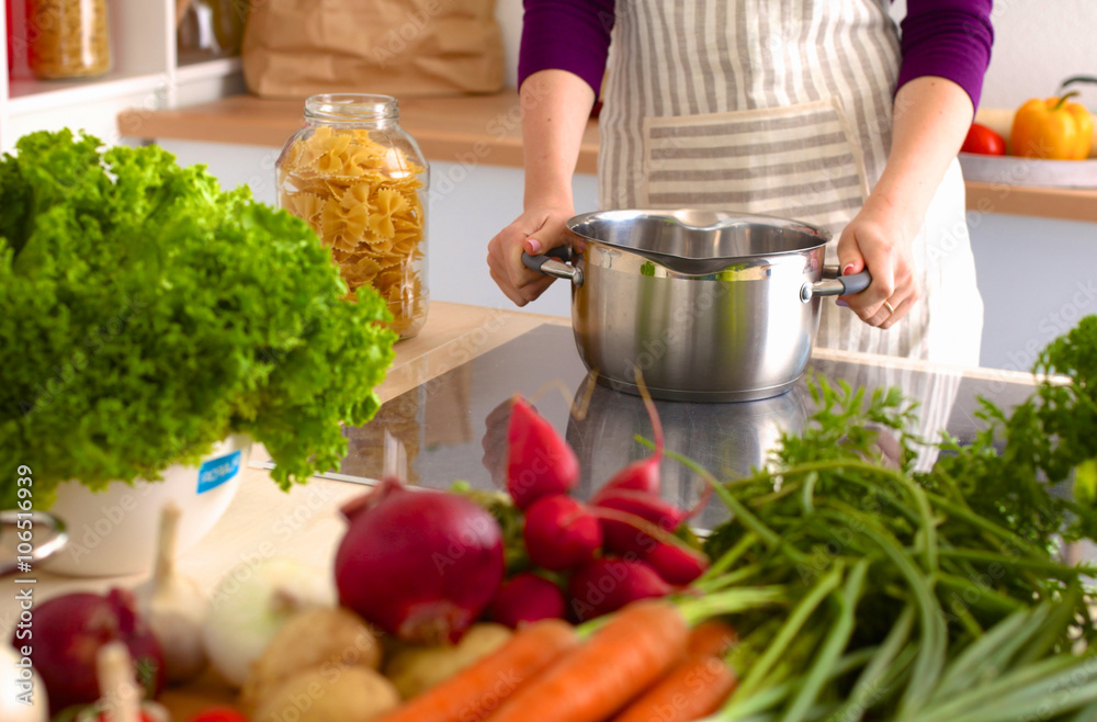 Young Woman Cooking in the kitchen. Healthy Food Young Woman Cooking in the kitchen. Healthy Food