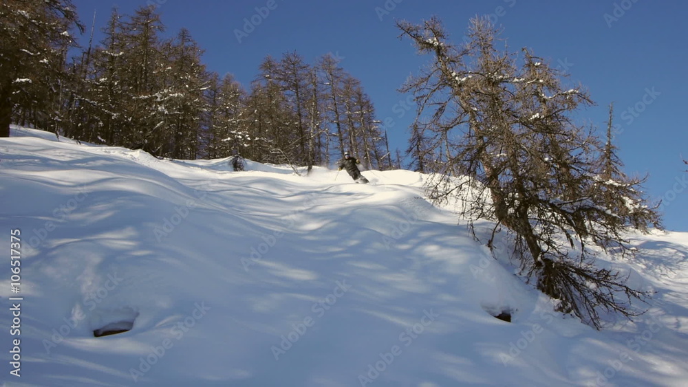 Off-piste mountain skier speeding downhill and jumps on small fresh powder pillows in sunny day.
Off-piste mountain skier speeding downhill and jumps on small fresh powder pillows in sunny day.
