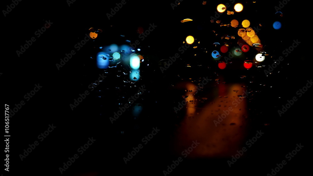 Defocused night traffic lights through wet windscreen Defocused night traffic lights through wet windscreen