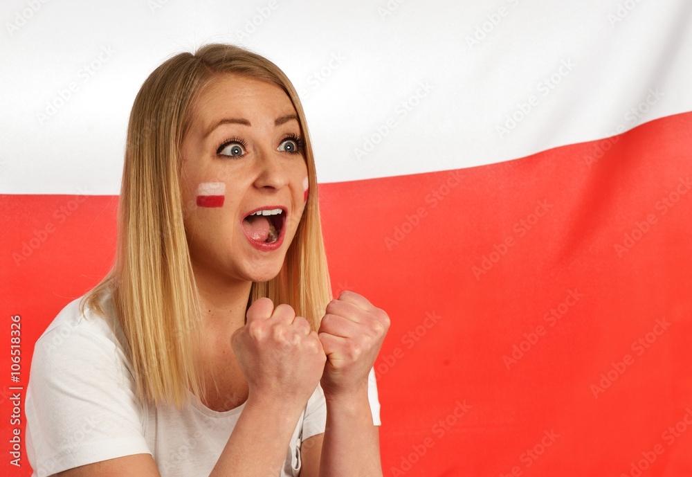 Polish fan cheers football team in the national colors.