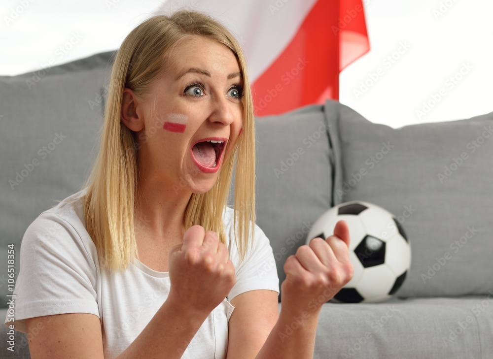 Polish fan cheers football team in the national colors.