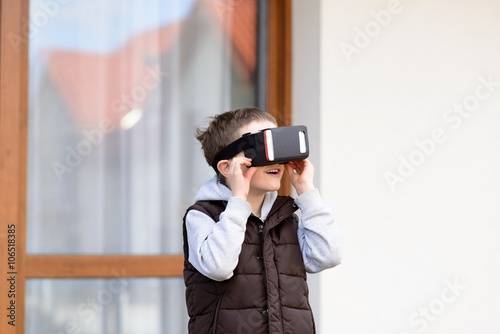 boy using VR virtual reality goggles