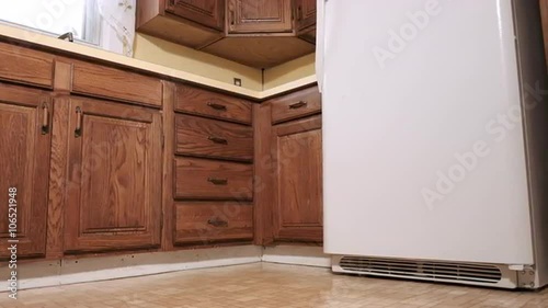 Wide panning shots of the corner of an old yellow out dated kitchen