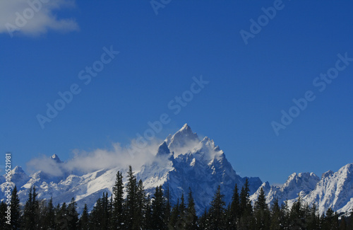 Snow mist blowing off mountain peak in Grand Teton National Park in Wyoming United States