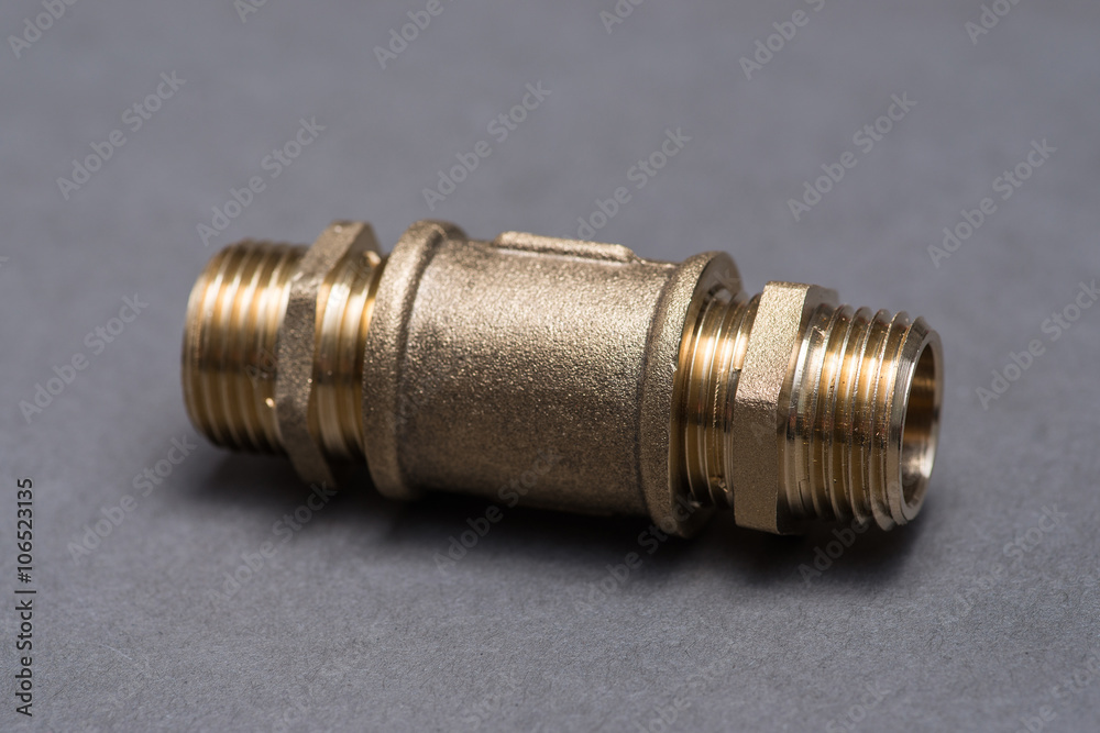 Brass plumbing fittings on grey table Brass plumbing fittings on grey table