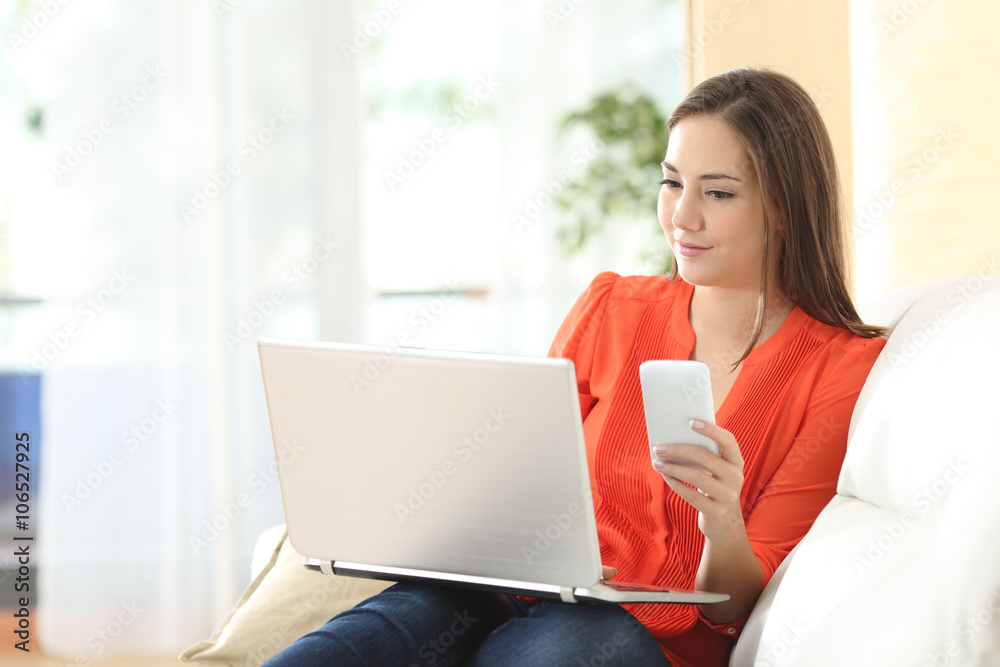 Woman working with laptop and phone Woman working with laptop and phone
