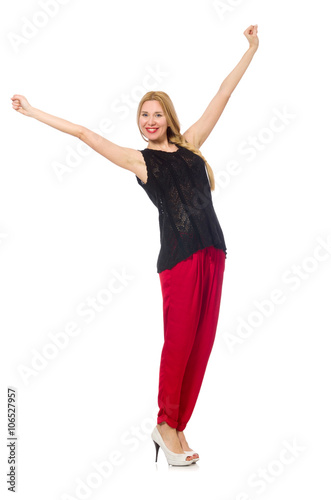 Tall young woman in red pants isolated on white