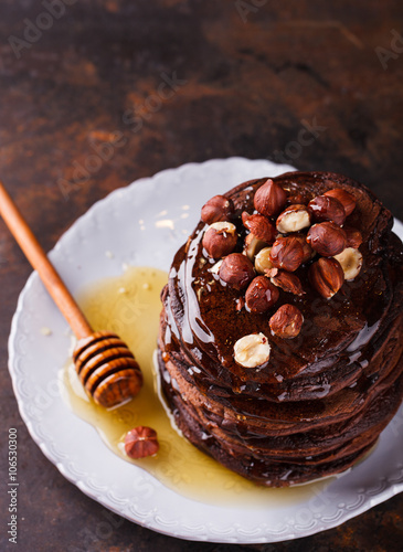 Chocolate pancake with honey and hazelnuts.selective focus