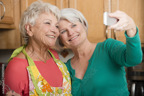 Senior Caucasian women taking self-portrait in kitchen