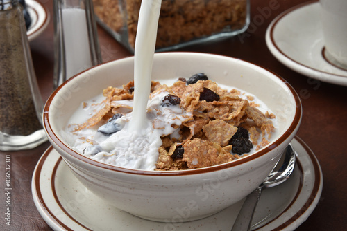 Fotografie, Obraz Pouring milk on bran cereal