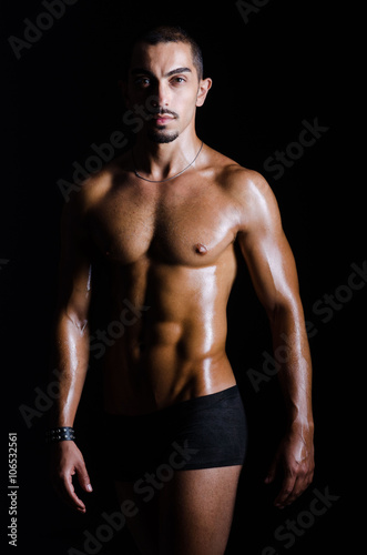 Ripped muscular man in sports concept