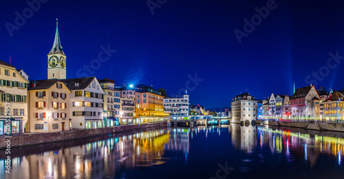 Night view of zurich from the munsterbrucke with building of the town hall on right side and saint peter church on left