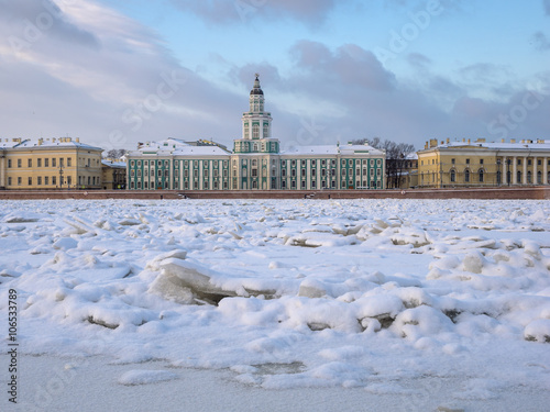 St. Petersburg in the winter. View through the frozen Neva River on the University Embankment and Kunstkamera building 