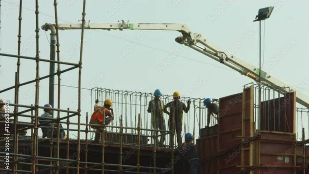Time Lapse shot of manual workers working at a construction site Time Lapse shot of manual workers working at a construction site