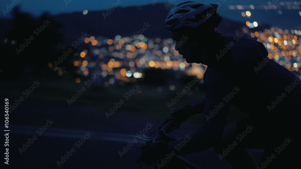 Medium shot of cyclist silhouette on mountain road Medium shot of cyclist silhouette on mountain road