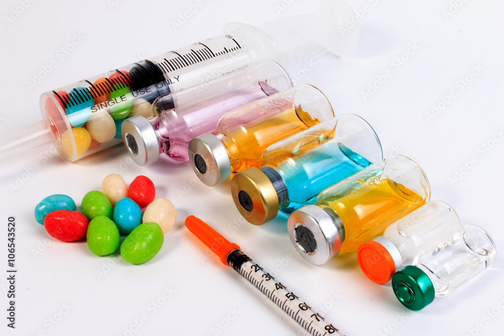A syringe and candy bottle isolate on white background. Protect against diabetes. A syringe and candy bottle isolate on white background. Protect against diabetes.