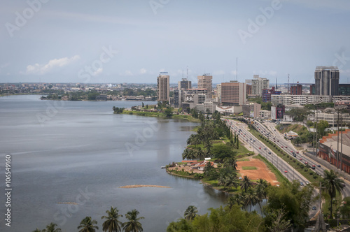 Abidjan, the economical capital of Ivory Coast (Cote d'Ivoire), it's business area Plateau with the Atlantic ocean bay in the background. April 2013 photo