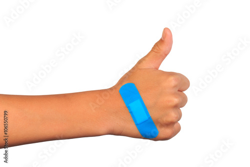 Fotografie Hand making thumbs up sign with adhesive bandage on