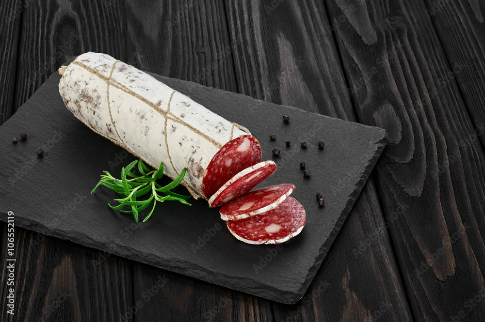 Dried salami with white mold on slate tray. Dried salami with white mold on slate tray.