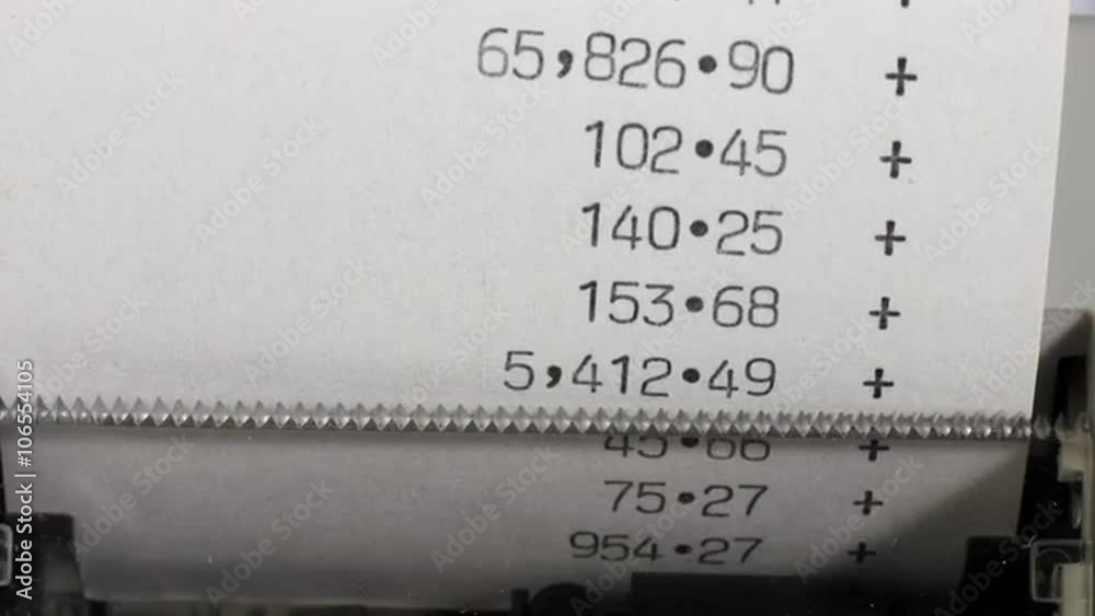 Track and zoom in over an office adding machine or calculator printout. Financial accounts and accounting. Time lapse.