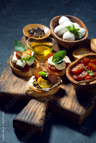 Photo Italian appetizers - various bruschettas, vertical