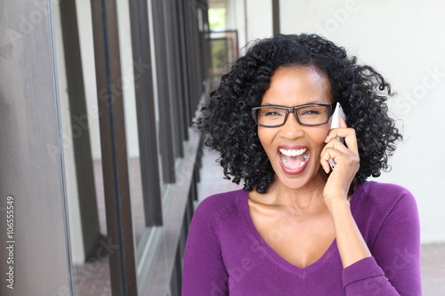 Mature gorgeous black woman on the phone getting great news 
