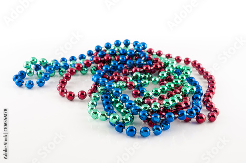 Mardi Gras beads with different colors: red, green and blue isolated on white background