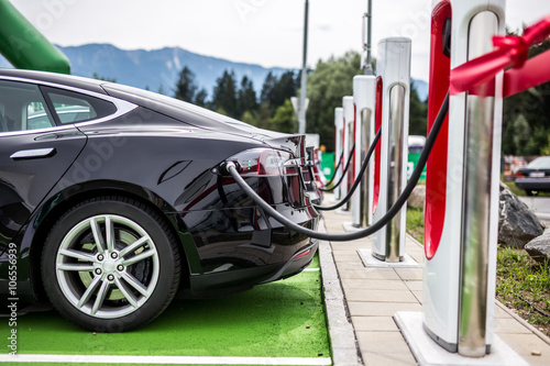 Electric car charging at electric petrol station - E-Mobility