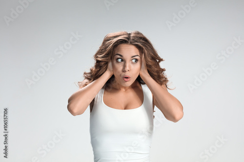 Portrait of young woman with shocked facial expression