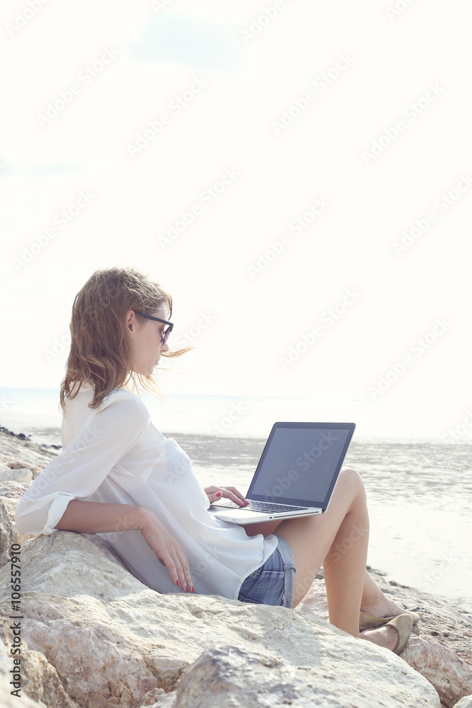 Outdoor portrait of young writer/blogger/freelancer/student with laptop