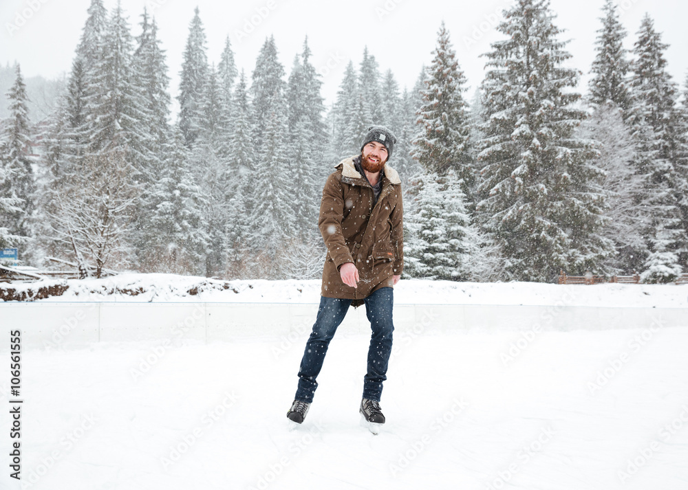 Young man ice skating outdoors