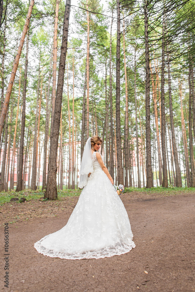 Gorgeous Blonde bride with bouquet outdoor, posing Gorgeous Blonde bride with bouquet outdoor, posing