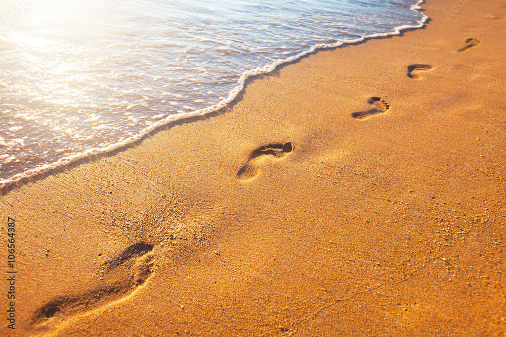 beach, wave and footprints at sunset time beach, wave and footprints at sunset time