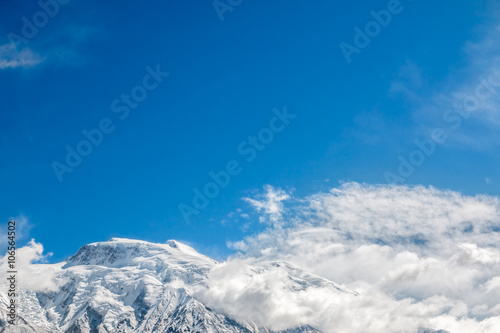 Mountain top covered with snow and clouds © beebright