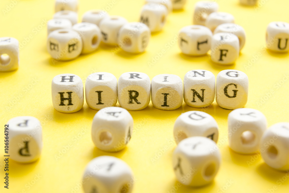 HIRING word written on wood block. Wooden Abc