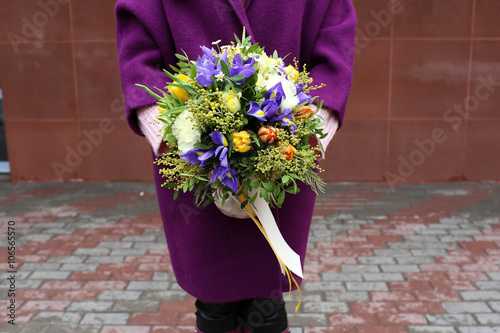 Beautiful bouquet of flowers in hands of the girl photo