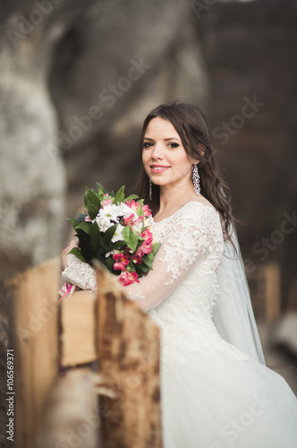 Beautiful bride posing near rocks with beautiful views