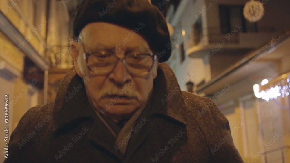 Old grandpa is the night city streets. The sad expression and problems. Old grandpa is the night city streets. The sad expression and problems.