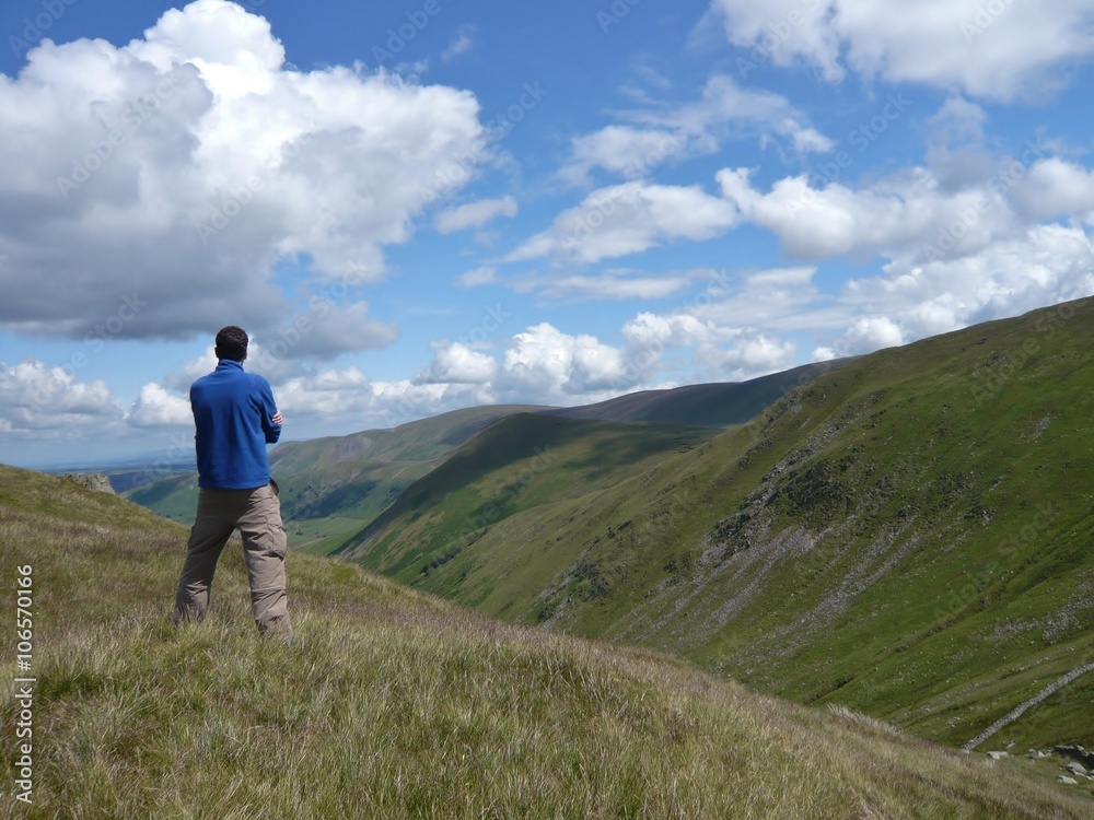 Contemplating a dramatic valley and sky