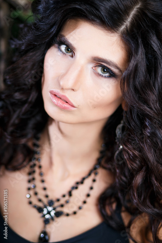 Close-up beauty portrait of gorgeous brunette woman with perfect makeup and hairstyle