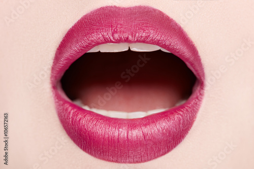 Close-up of open mouth woman with beautiful red lips