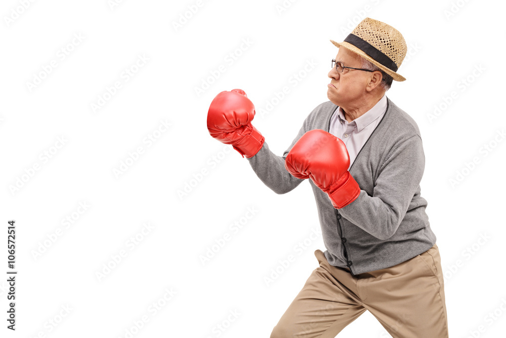 Angry senior with red boxing gloves