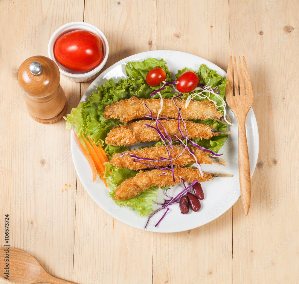 Fish fry in plate on wood desk Fish fry in plate on wood desk
