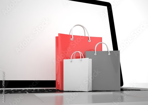 laptop and shopping pags on white background. 3D rendering.