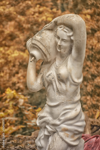 statue pouring the water in beautiful garden  © Dmytro