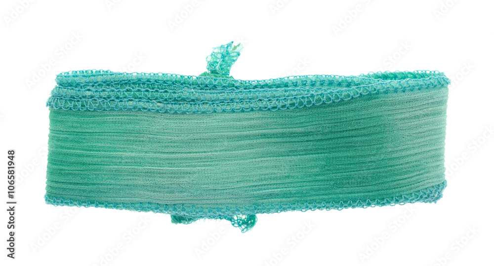 Fototapeta premium Green ribbon cloth material on a white background